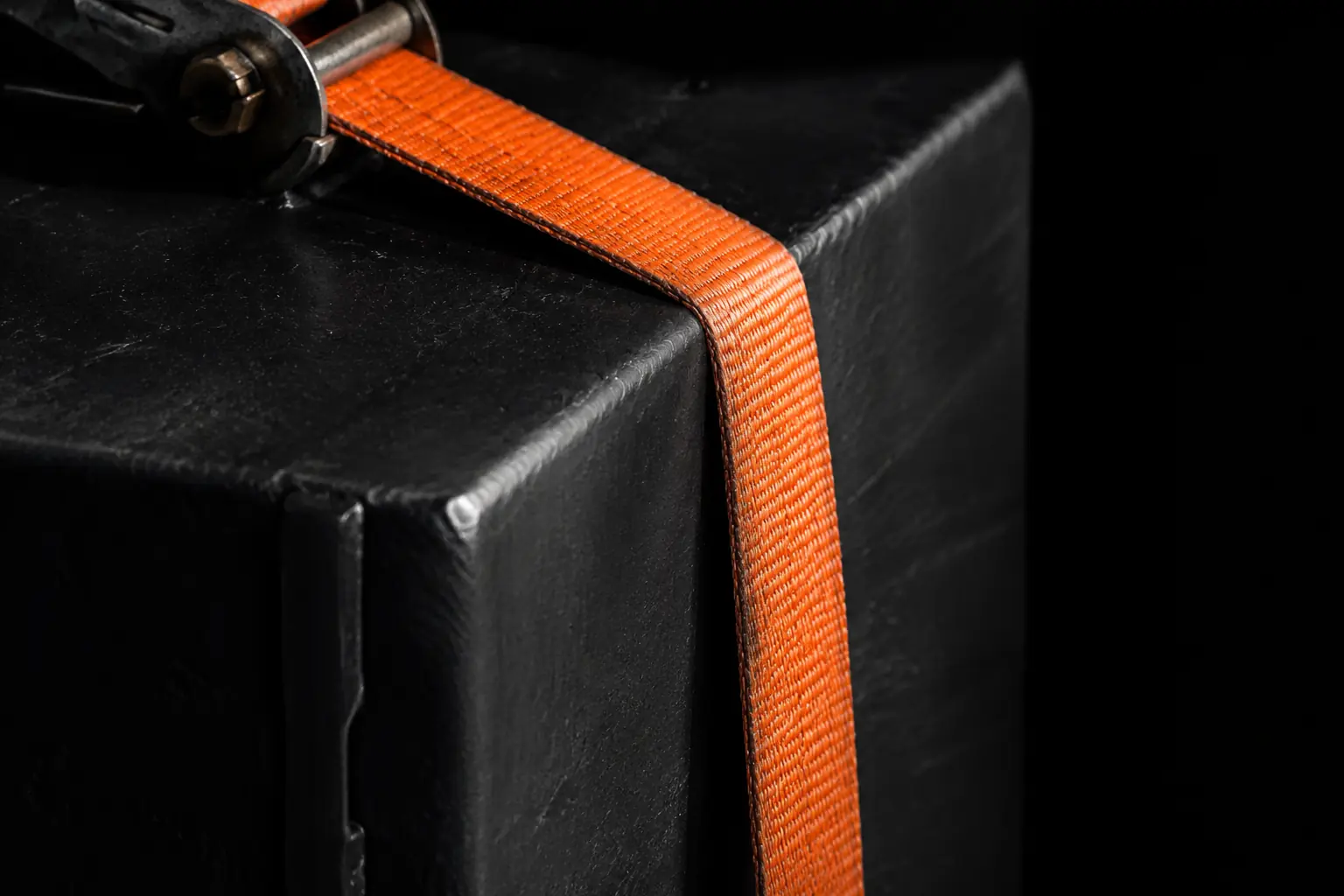 Close-up of a ratchet strap securing cargo on a flatbed